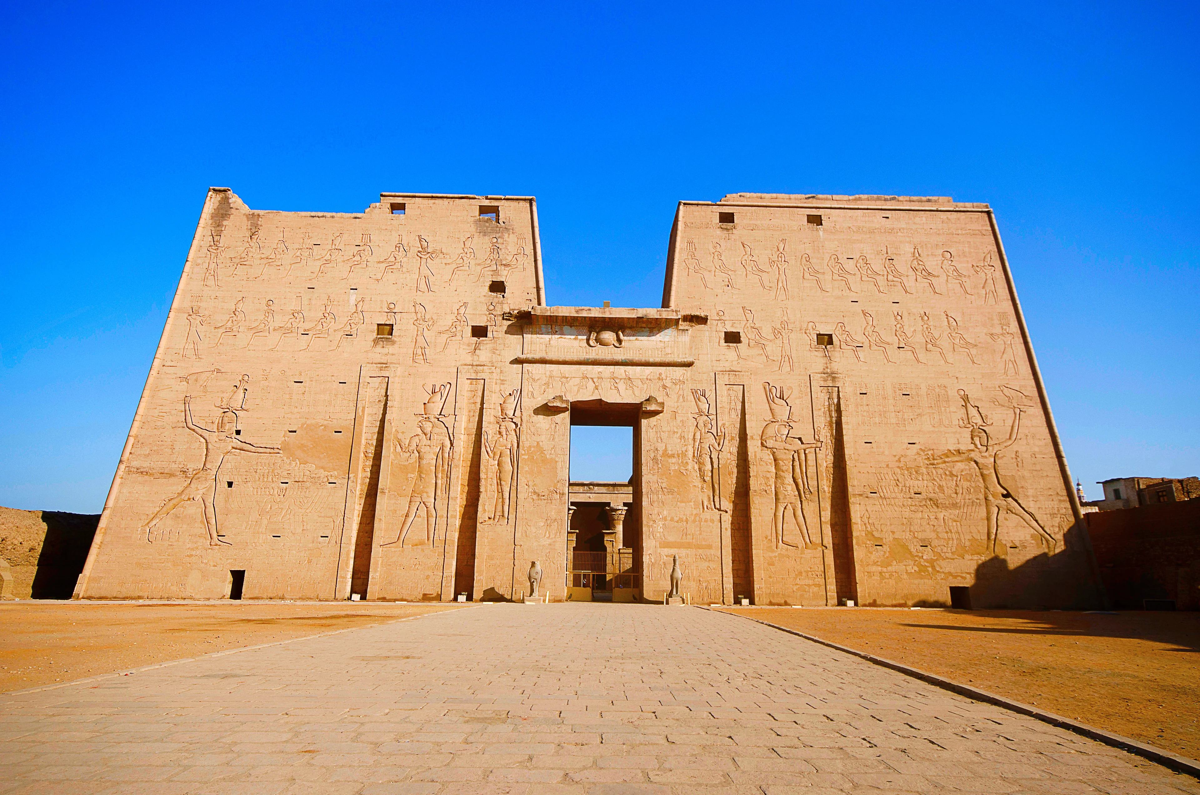 The main entrance of Edfu Temple showing the first pylon, Dedicated to the Falcon God Horus, Located on the west bank of the Nile, Edfu, Upper Egypt 