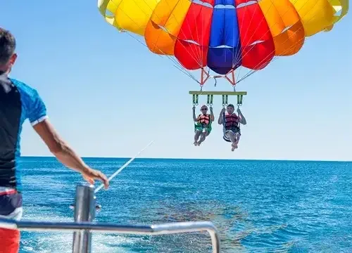 Parasailing adventures at Orange Bay Hurghada - colorful parasail gliding high above turquoise waters with breathtaking views of the Egyptian coastline