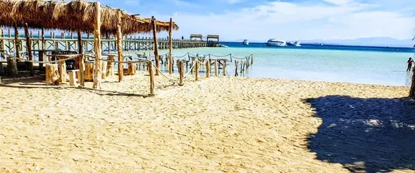 Premium beach comfort at Orange Bay Hurghada - luxury sunbeds and umbrellas on pristine white sandy beaches with turquoise water views