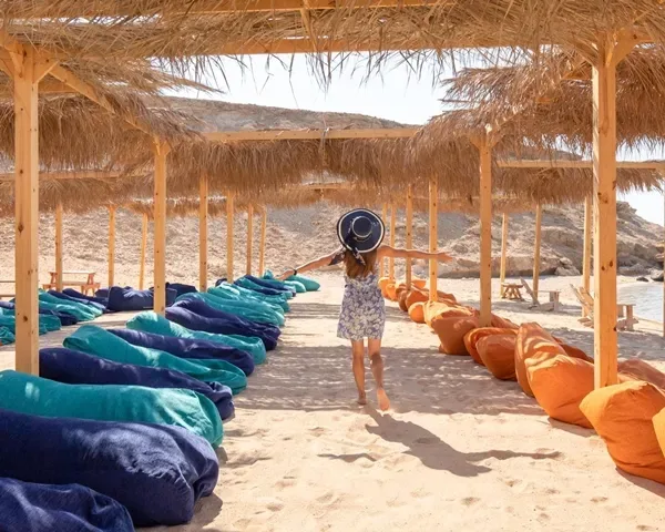 Instagram-worthy spots at Orange Bay Hurghada - beautiful beach with traditional wooden structures nestled close to the clear, inviting turquoise water