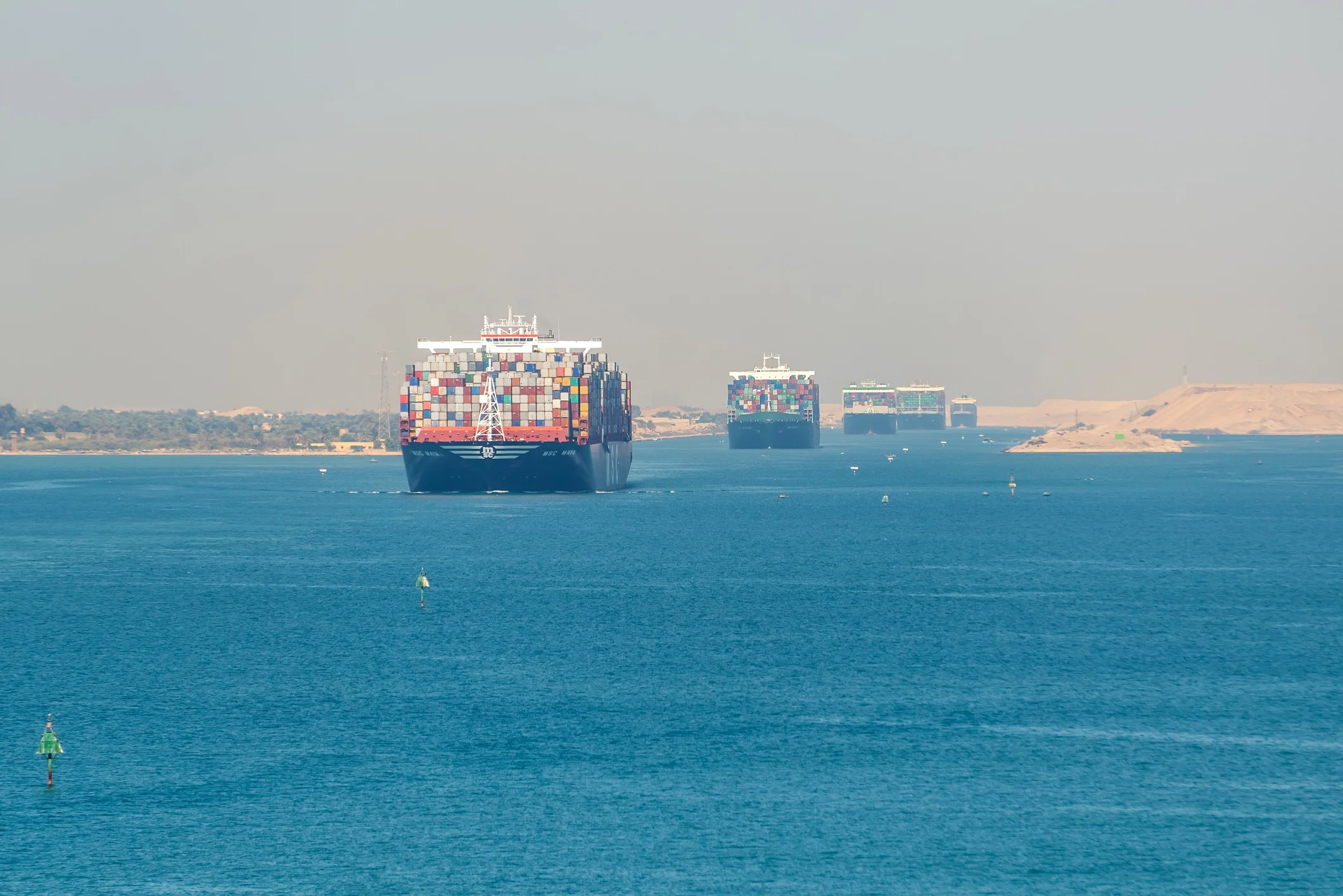 Container ships moving through the Suez Canal