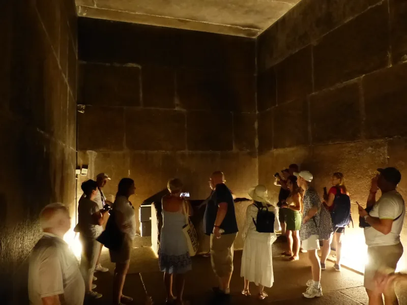 Visitors in the granite burial chamber deep inside the Great Pyramid